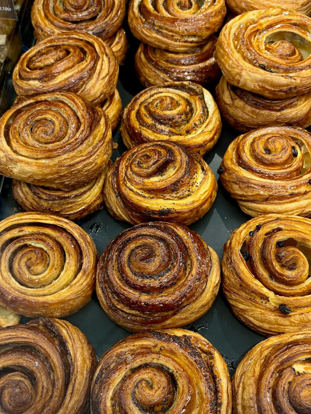Freshly baked Danish cinnamon pastries on a tray